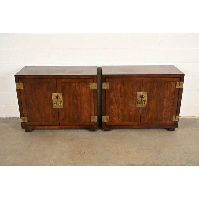 A gorgeous pair of mid-century modern Hollywood Regency Campaign style buffet servers or bar cabinets By Henredon USA,...