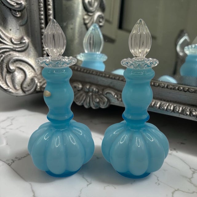 A Pair of Fenton Art Glass Company blue opalescent color which appears to glow with an inner light with an elegant melon...