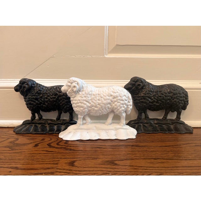 These Trio Antique 19thC Cast Iron Ram Doorstops consist of two black and one white free-standing heavy door stop. Made...