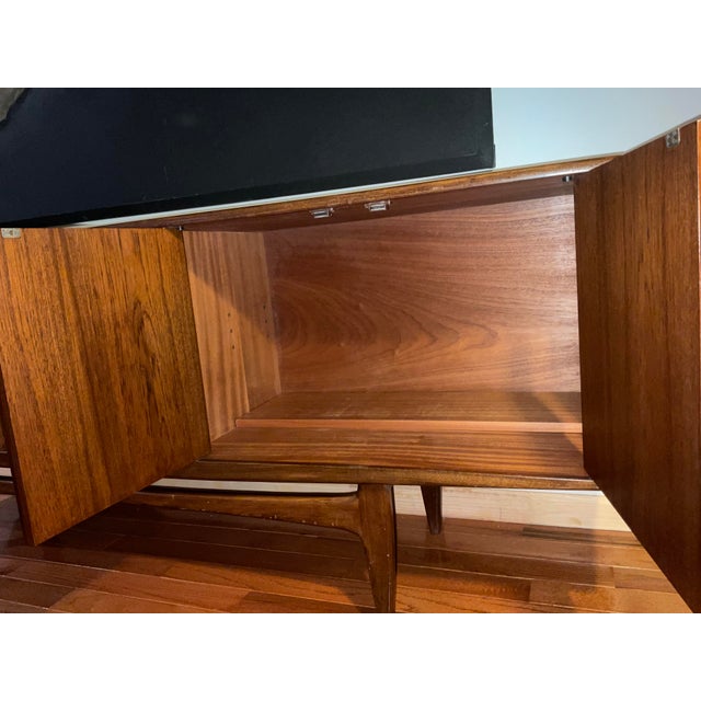 1960s LONG MID-CENTURY TEAK CREDENZA by VICTOR WILKINS. Pair of doors on each end, opens to ONE adjustable shelve. Center...