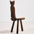 A handcrafted chair with cowhide upholstery from the 1970s. The chair is foldable and has three legs. with some surface...