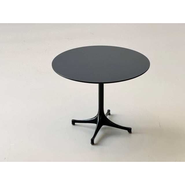 A classic pedestal side table from the 1950s, featuring the iconic, organic design language of mid-century modernism. The...
