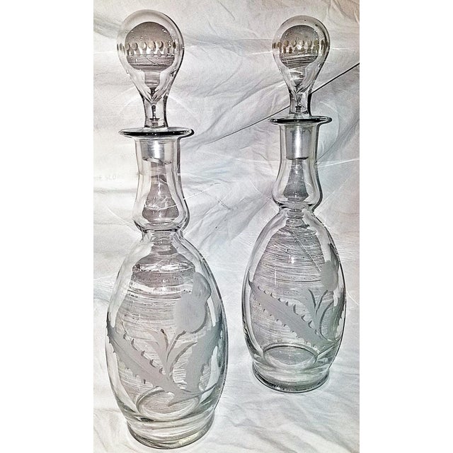 A pair of svelte etched decanters with stoppers by Hawkes, one of the top crystal makers in the world. Good feel in the...