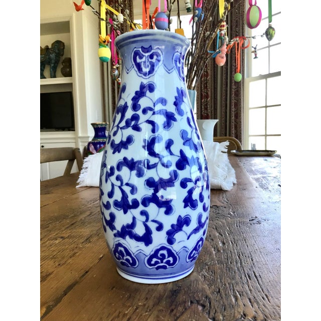 Vintage blue and white Chinese vase in classic elegant design. 10” Tall.