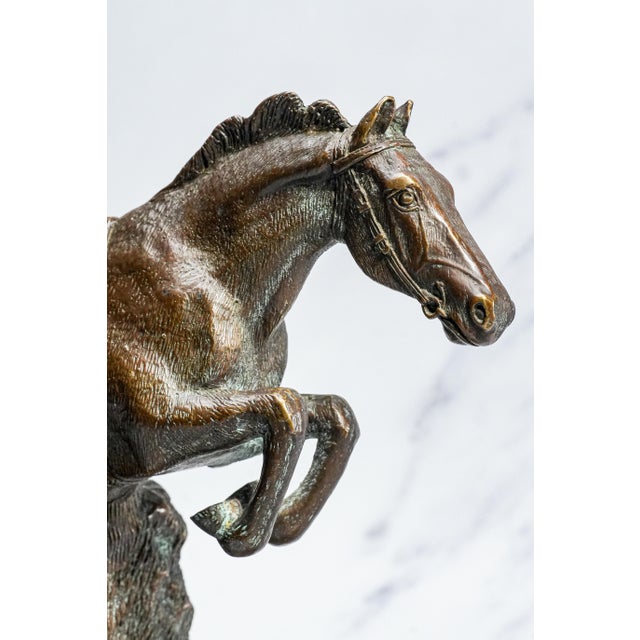 A commanding tribute to equestrian strength and elegance, this finely cast bronze horse sculpture captures a powerful...