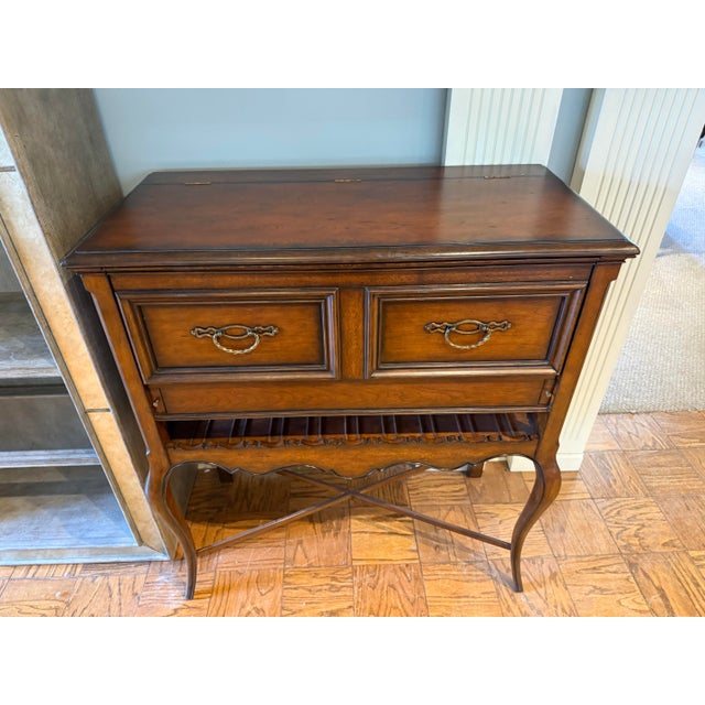Flip-top charm meets hardworking storage in this elegant cherry wine cabinet bar. Rich warm wood, cabriole legs and...