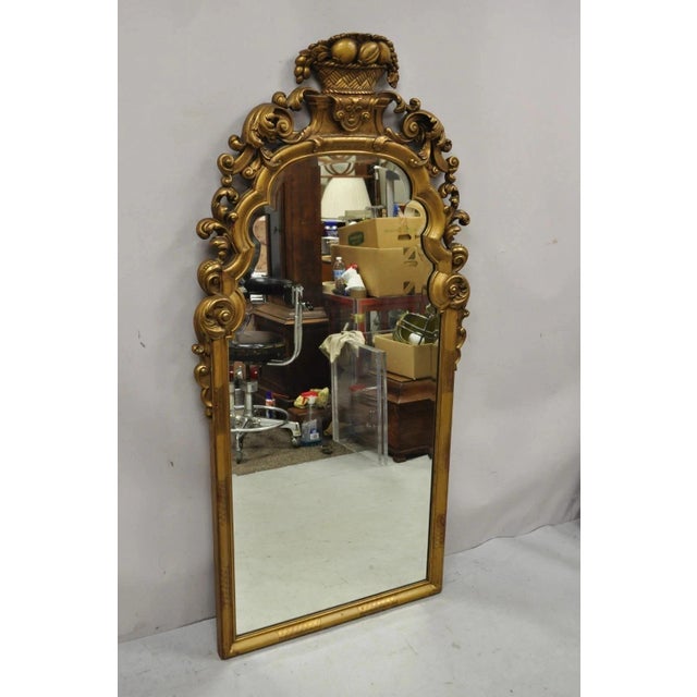 Antique French Rococo Style Gold Giltwood 65" Harvest Carved Fruit Basket Wall Mirror. Item features a large wooden frame,...