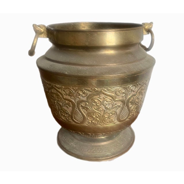 Antique Chinese brass cachepot with intricate incised design. Ring handles at each side mounted with a dragon detail.