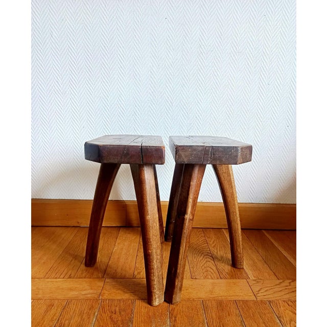 Pair of tripod milking stools, made of solid wood in the Brutalist style, circa 1950. Beautiful lines of gently curved...