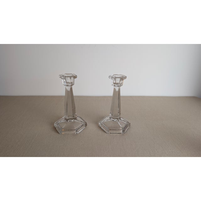 A pair of vintage clear glass candlesticks with hexagonal bases, ~c. 1950. Made of glass, these candle holders have a...