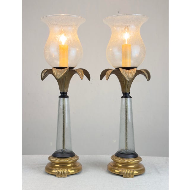 A pair of beautiful brass palm tree table lamps with bubbles blown glass bodies and hurricane shades. Nicely detailed...