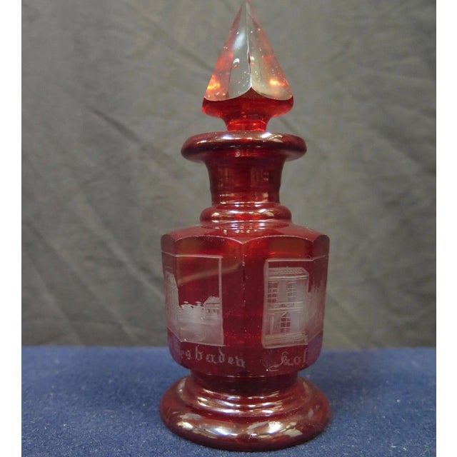 This vintage mid 19th century Bohemia souvenir cologne/scent bottle displays detailed hand cut frosted scenes. The squatty...