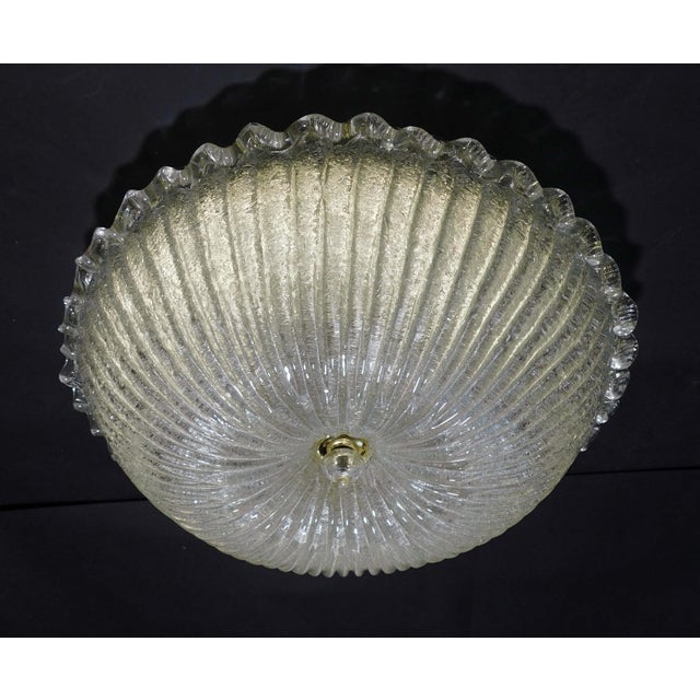 Italian flush mount with a Murano glass diffuser hand blown in Graniglia technique to produce granular texture, mounted on...