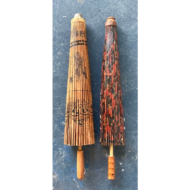 This exquisite pair of vintage Asian parasols is a masterful celebration of traditional craftsmanship and bohemian charm....