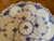 Interior decorated with classic cobalt blue stylized flowers, Palmettos, and fish scale textures at the edge