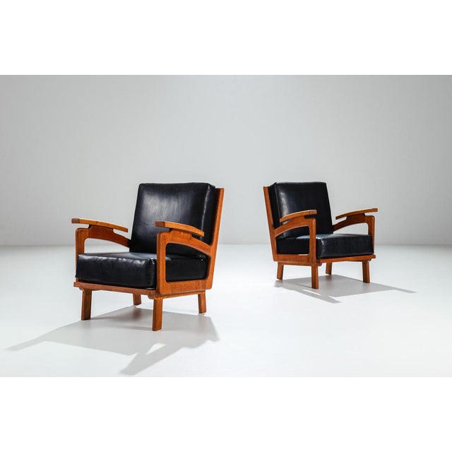 This striking pair of vintage lounge chairs showcase quiet strength and refined craftsmanship. Expertly constructed from...