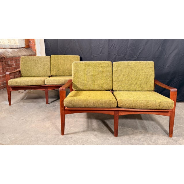 This matched pair of teak loveseats by Arne Wahl Iversen for Komfort of Denmark are a classic expression of Scandinavian...