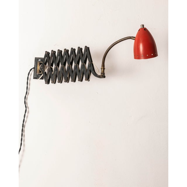 A unique articulated wall lamp made in France during the 1950s and attributed to Robert Mathieu. The piece combines an...