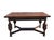 A substantial early 20th-century Jacobean Revival dining table crafted in richly grained oak and featuring an integrated...