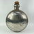 Vintage metal bottle from India with a rounded body. Made from polished metal with visible wear and repair marks. It has a...