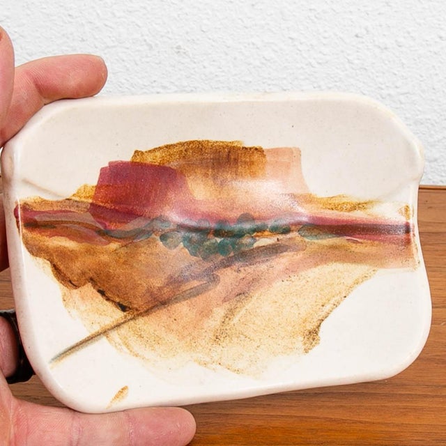 Mid Century Modern art pottery ashtray with a unique glaze design. Unknown maker.