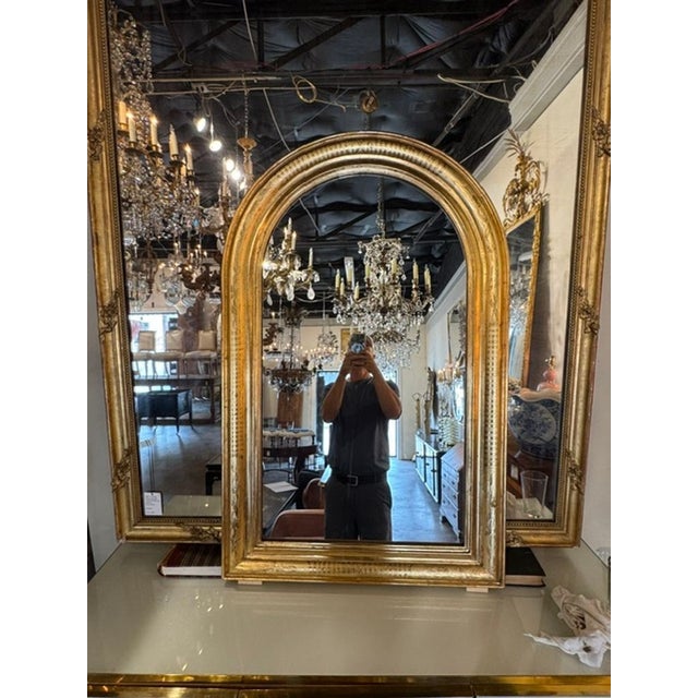 French Louis Philippe Gold Leaf Arched Mirror. A French Louis‑Philippe gold‑leaf arched mirror is a 19th‑century French...
