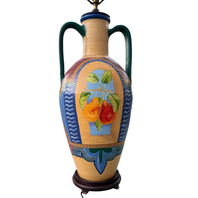 Vintage hand painted two handled urn table lamp featuring a vibrant color palette and artistic design of fruit and foliage...