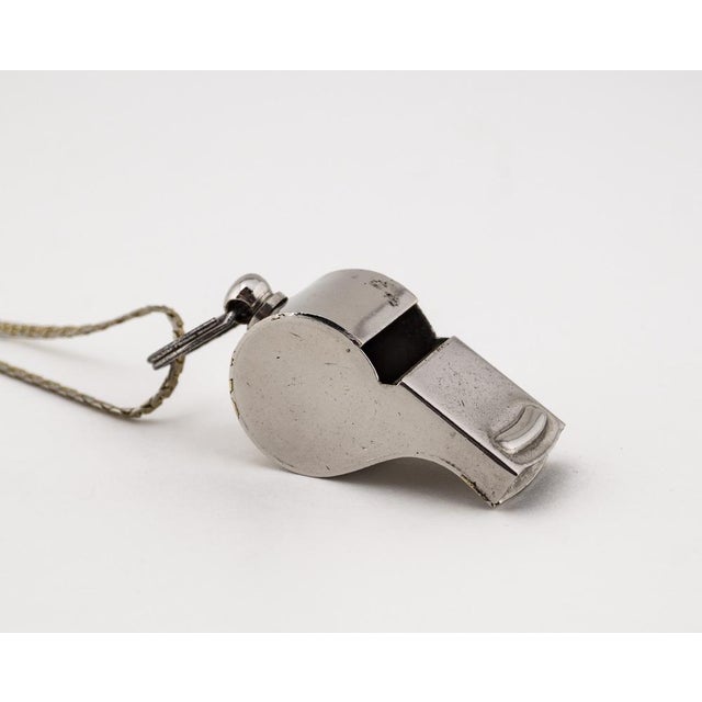A metal whistle from the 1940s made in Germany. The object can be worn as a historical collectible or as a striking...