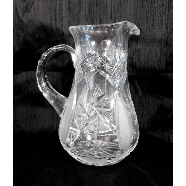 This is a large cut crystal pitcher by Crystal Clear of Poland. It has a sticker on the front as shown. The pitcher has a...