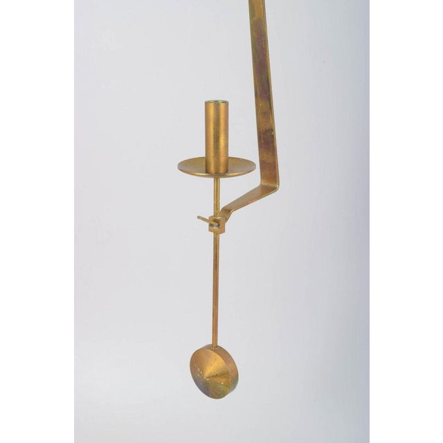 Pierre Forsell for Skultuna, wall hanging pendulum candle holder. Minimalist candle holder in brass with pendulum...