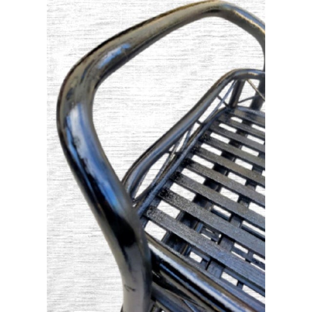 A wonderful custom painted vintage rattan rolling bar cart. The cart was custom painted in a black gloss paint. The entire...