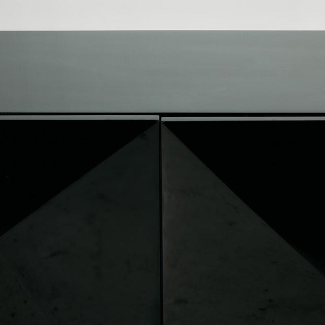 A really modern piece from the 2000s. The sideboard has four doors, a high-gloss lacquered finish and steel legs. with...