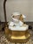 This is a unique porcelain lamp featuring a griffin with a floral painted urn between its wings. The linen shade looks...