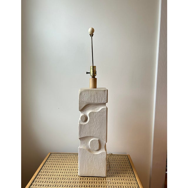 A large plaster table lamp. The lamp has different abstract intaglio decoration on each side. Signed "Casual Lamps, 1987"....