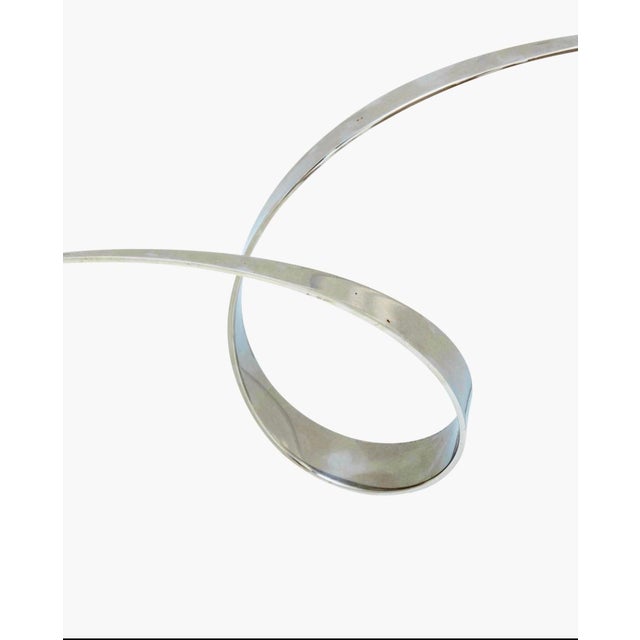 Elijah David Herschler (1940-2023) Ribbon sculpture Chromed metal 25.25" H x 24.5" W x 9" D approximately Modern, abstract...
