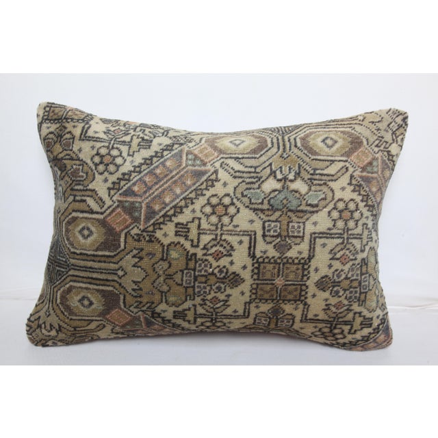 This handcrafted lumbar pillow cover is made from a vintage tribal Turkish Rug, showcasing a beautifully aged patina and...