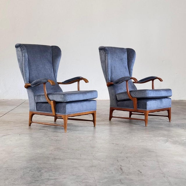 A rare and elegant pair of wingback armchairs designed by Paolo Buffa and produced by Framar in the 1950s. Executed in...