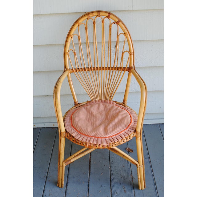 This vintage 1960's fan back bamboo arm chair is a size that works well in a small space. It comes with a cute hand made...
