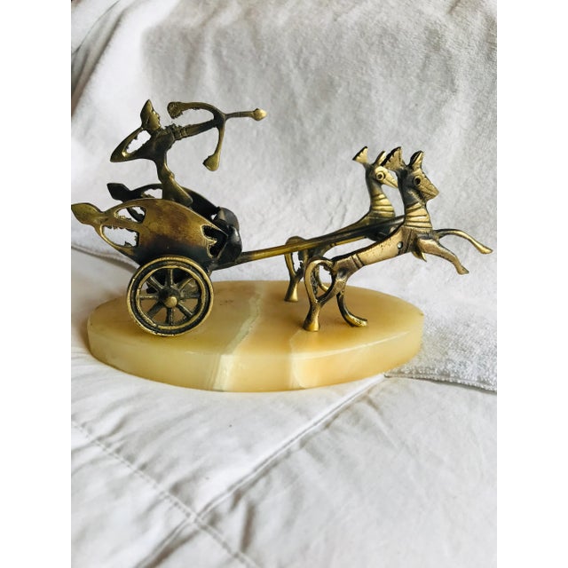 Metal Roman warrior with bow aimed while riding in a chariot pulled by horses. Mounted on a marble base. Could be used as...