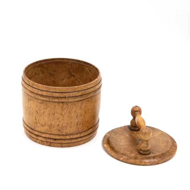 Round carved birch treenware tobacco jar, with handle top; English, circa 1820. 6 in. 15 cm., diameter: 5 in. 13 cm.