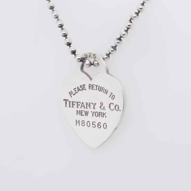A fine silver heart tag necklace. By Tiffany & Co. In sterling silver. With a heart shaped pendant reads "Please Return to...