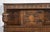 Oak court cupboard, the carved and panelled canted cupboard supported on turned cup and cover supports and arcaded frieze....