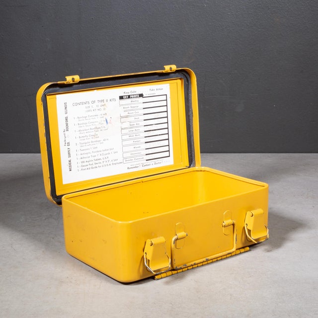 ABOUT A mid-century metal first aid box featuring a vibrant, eye-catching bright yellow enamel finish with the classic...