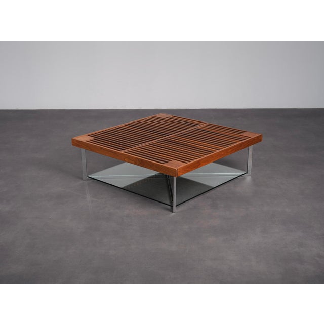 A refined ponton coffee table designed by osko + deichmann for ligne roset in 2006. The design combines a warm walnut...