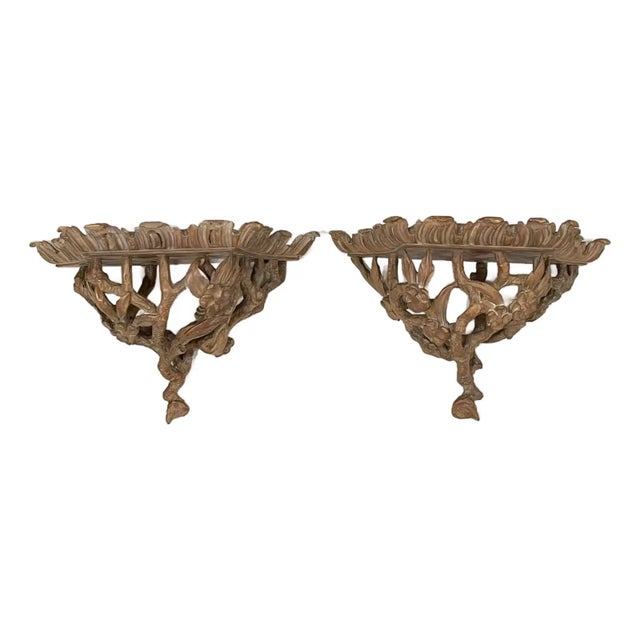 Cerused wood wall shelves. Detailed carved branches and flowers. Flat Shelf area measures 9”x 6”. From a prominent...