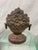 Antique iron doorstop with worn painted finish-flowers in basket on pedestal base. 8” tall 5” wide 2 1/4” deep