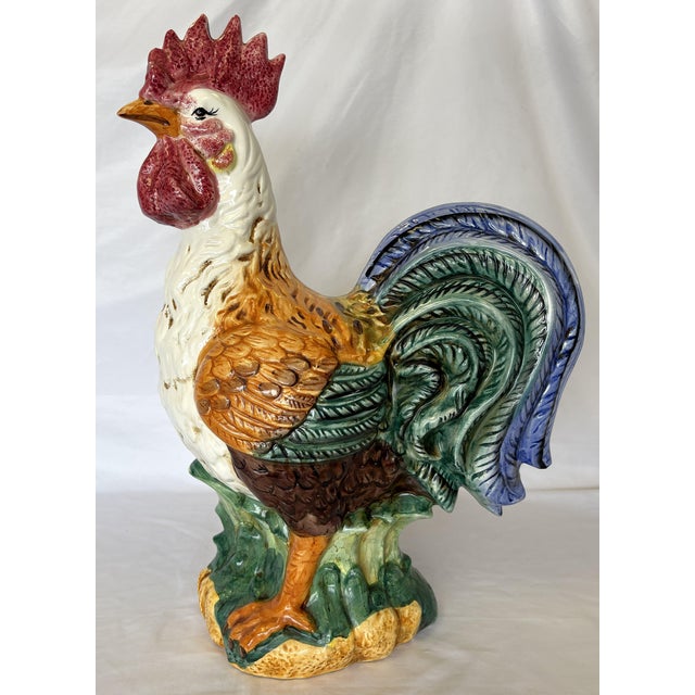 Pretty ceramic majolica style rooster from the late 20th century. This large rooster is painted in bright shades of...