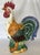 Pretty ceramic majolica style rooster from the late 20th century. This large rooster is painted in bright shades of...