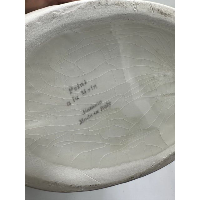 This is a charming hand-painted covered dish, Italian pottery. Form & Style • Shape: A rounded ceramic dish with a fitted...