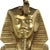 Vintage brass pharaoh table lamp with a dark blue rectangular lampshade; the pharaoh figure stands on a black wooden base....